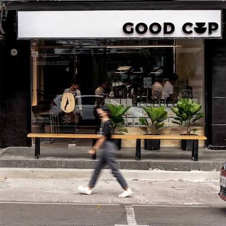 The Good Cup storefront: the sign, a glass front, a bench and plants